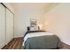 Cozy bedroom with hardwood floors and a picture above the bed at 10239 W Fair Ave # A, Littleton, CO 80127