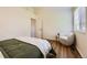 Bright bedroom featuring hardwood floors, a chair, and a wardrobe at 10239 W Fair Ave # A, Littleton, CO 80127