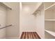 Walk-in closet with wood floor and built-in shelving system for optimal storage and organization at 10239 W Fair Ave # A, Littleton, CO 80127