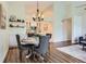 Cozy dining area with modern lighting and decor, flowing into living area at 10239 W Fair Ave # A, Littleton, CO 80127