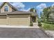 Exterior view showcasing the home's facade, two-car garage and well-maintained landscaping at 10239 W Fair Ave # A, Littleton, CO 80127
