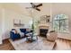 Spacious living room with large windows, a cozy fireplace, and stylish furnishings at 10239 W Fair Ave # A, Littleton, CO 80127