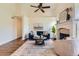 Bright living room featuring a fireplace, vaulted ceilings, and modern decor at 10239 W Fair Ave # A, Littleton, CO 80127