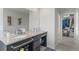 Bathroom with double sinks, large mirror, and walk-in closet at 4670 Tanner Peak Trl, Brighton, CO 80601