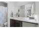 Modern bathroom featuring double sinks, a large mirror, and a shower with a patterned curtain at 4670 Tanner Peak Trl, Brighton, CO 80601