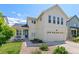 Charming two-story home with a covered front porch and an attached two-car garage at 4670 Tanner Peak Trl, Brighton, CO 80601