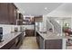 Stylish kitchen boasts stainless steel appliances, granite countertops, plenty of cabinet space, and hardwood flooring at 4670 Tanner Peak Trl, Brighton, CO 80601