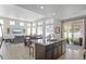 Bright, open concept kitchen and dining area with stainless steel appliances and sliding glass door leading to backyard at 4670 Tanner Peak Trl, Brighton, CO 80601