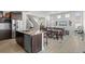 Open concept kitchen and living room featuring a kitchen island, stainless steel appliances, and hardwood flooring at 4670 Tanner Peak Trl, Brighton, CO 80601