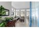 Bright living room featuring large windows, modern furnishings, and a cozy seating area at 4670 Tanner Peak Trl, Brighton, CO 80601