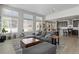 Spacious living room open to kitchen, featuring modern decor and plenty of natural light at 4670 Tanner Peak Trl, Brighton, CO 80601