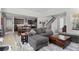 Open-concept living area with view of kitchen, staircase, and contemporary furnishings at 4670 Tanner Peak Trl, Brighton, CO 80601