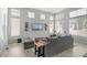 Airy living room with high windows, contemporary decor, and comfortable gray sofa at 4670 Tanner Peak Trl, Brighton, CO 80601