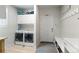 Organized mudroom with a washer, dryer, cabinets, hooks, bench, and an exterior door at 4670 Tanner Peak Trl, Brighton, CO 80601