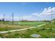 Community soccer field featuring lush green turf, goal nets, and a walking path, perfect for outdoor activities at 4670 Tanner Peak Trl, Brighton, CO 80601