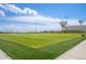 Expansive community sports field with well-maintained artificial turf and the city's water tanks in the background at 4670 Tanner Peak Trl, Brighton, CO 80601