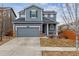 Two-story house with gray siding, a two-car garage, and a well-maintained lawn at 15162 Jakarta Cir, Parker, CO 80134