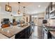 Kitchen with granite island, stainless steel appliances, and a view to the living area at 15162 Jakarta Cir, Parker, CO 80134