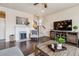 Living room featuring a fireplace, hardwood floors, and a large TV at 15162 Jakarta Cir, Parker, CO 80134