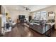 Living room with hardwood floors, a fireplace, and a comfortable sectional sofa at 15162 Jakarta Cir, Parker, CO 80134