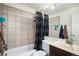 Clean bathroom features a shower-tub combination, updated fixtures, neutral tile, and ample space at 2280 S Jasper Way # B, Aurora, CO 80013