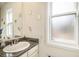 Cozy bathroom featuring granite countertops, a sink, a mirror, and a window providing natural light at 2280 S Jasper Way # B, Aurora, CO 80013