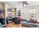 A bedroom features laminate floors, a ceiling fan, shelving units, and natural light from a window with blinds at 2280 S Jasper Way # B, Aurora, CO 80013