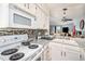 Well-equipped kitchen features white appliances, granite countertops, mosaic backsplash, and access to the living areas at 2280 S Jasper Way # B, Aurora, CO 80013