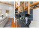 Modern bar area featuring marble countertops, custom cabinetry, and a stylish backsplash and open shelving at 110 Windwood Cir, Breckenridge, CO 80424
