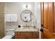 Stylish bathroom features granite counters, modern fixtures, and a round mirror at 110 Windwood Cir, Breckenridge, CO 80424