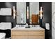 Modern bathroom with double sinks, a vanity, large mirrors, and stylish lighting sconces at 110 Windwood Cir, Breckenridge, CO 80424