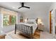 Bright bedroom featuring a rustic wood bed frame and a picturesque view of the surrounding nature at 110 Windwood Cir, Breckenridge, CO 80424