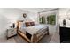 Serene bedroom featuring a unique wood frame bed and natural light streaming through the window at 110 Windwood Cir, Breckenridge, CO 80424