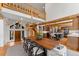 Bright dining area with open staircase to the second level, views into the kitchen, and wooden dining table at 110 Windwood Cir, Breckenridge, CO 80424