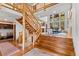 Grand foyer features hardwood floors, a log staircase, and expansive windows with views at 110 Windwood Cir, Breckenridge, CO 80424