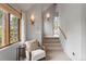 Cozy hallway with stairs leading to a well-lit upper level and a scenic nature view at 110 Windwood Cir, Breckenridge, CO 80424