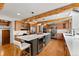 Spacious kitchen featuring wood cabinets, an island with a wine rack, and rustic exposed beams at 110 Windwood Cir, Breckenridge, CO 80424
