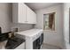 Bright laundry room with modern washer, dryer, and cabinetry at 110 Windwood Cir, Breckenridge, CO 80424
