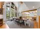 Spacious living area featuring vaulted ceilings, a large dining table, and large windows with natural lighting at 110 Windwood Cir, Breckenridge, CO 80424
