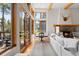 Bright living room features hardwood floors, a stone fireplace, and large windows with a view at 110 Windwood Cir, Breckenridge, CO 80424