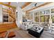 Cozy living room with an open staircase, beamed ceilings, a sectional sofa and views through the windows at 110 Windwood Cir, Breckenridge, CO 80424