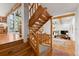 Light-filled view of staircase leading to the living room with wood steps and log railing and support structure at 110 Windwood Cir, Breckenridge, CO 80424