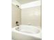 Close-up of a bathtub with tiled walls and bronze hardware in the bathroom at 3854 S Dayton Way # 308, Aurora, CO 80014