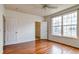 Bedroom showcasing hardwood floors, a ceiling fan, and a window overlooking the neighborhood at 3854 S Dayton Way # 308, Aurora, CO 80014