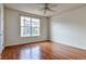 Bedroom with hardwood floors, a large window, and a ceiling fan, offering natural light at 3854 S Dayton Way # 308, Aurora, CO 80014