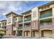 A beautiful brick building with tan siding, balconies, and individual garages with archways at 3854 S Dayton Way # 308, Aurora, CO 80014
