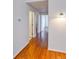 A long hallway with wood floors and white walls leads to other areas of the home at 3854 S Dayton Way # 308, Aurora, CO 80014