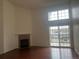 Bright living room with a fireplace, hardwood floors, and a large window with a balcony at 3854 S Dayton Way # 308, Aurora, CO 80014