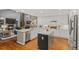 Open kitchen featuring modern appliances, a large center island, and bright lighting at 320 Crossing Cir, Castle Pines, CO 80108