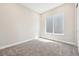 Bright bedroom features neutral walls, carpet, and a window that fills the space with natural light at 5909 S Platte Canyon Dr, Littleton, CO 80123